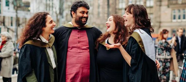 Four graduating students in Bristo Square