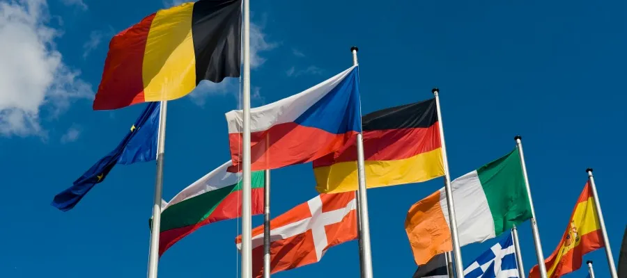 Flags of different European countries against a blue sky