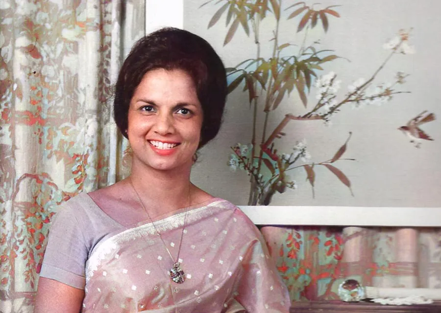 Saroj Lal in a light pink sari in front of a painting