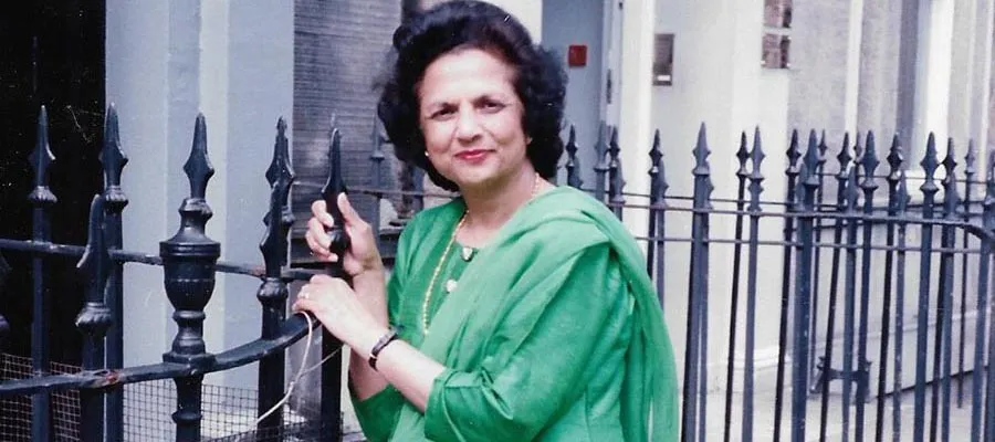 Saroj Lal in green sari standing by railings on Forth Street