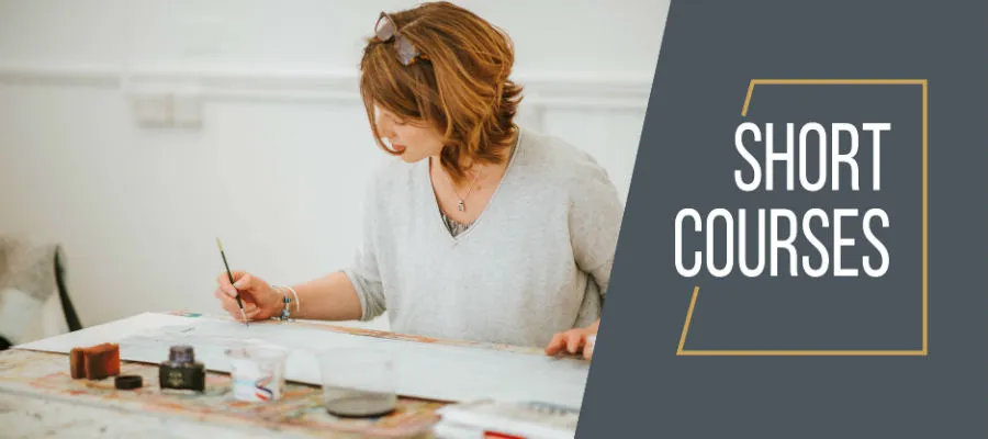 A woman painting during short course class.