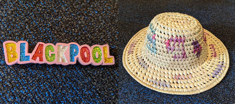 Colourful fridge magnet saying 'Blackpool' and hat with blue and purple streaks.