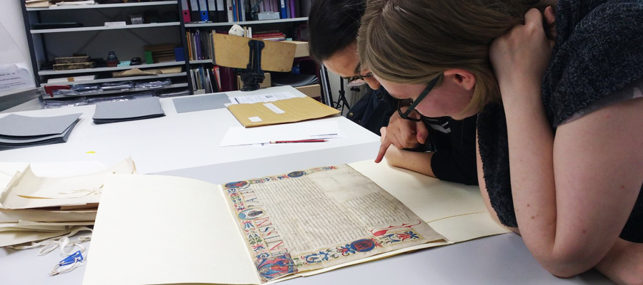 A student studies one of the manuscripts from the Laing collection