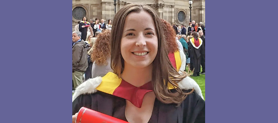 Jenna Kibler in her graduation down smiling.