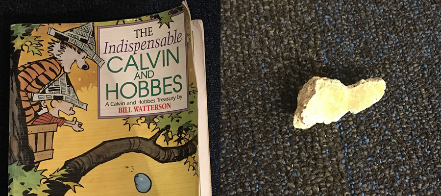 Cover of 'The Indispensible Calvin and Hobbes' by Bill Watterson and an alleged piece of the Berlin Wall.